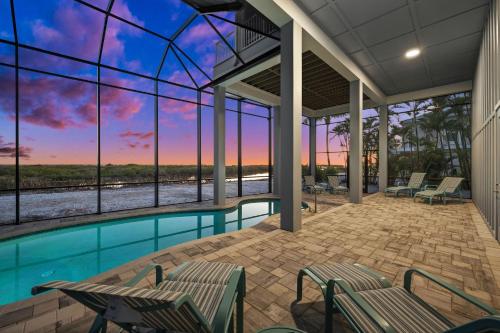 a swimming pool with a view of the ocean at Papa's Boat House - 8214 Estero Blvd home in Fort Myers Beach