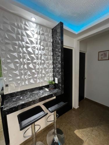 a bar in a room with a blue ceiling at Departamento en Acapulco Diamante planta baja in La Sabana