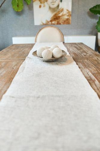 a wooden table with a plate on top of it at Luxury Forest Oasis 4 beds 4 baths and Hot tub in Cocagne 