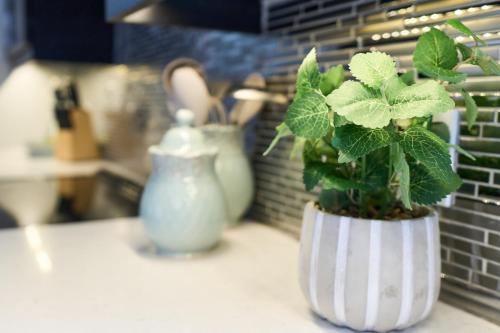 a white vase with a plant in it on a counter at Luxury Forest Oasis 4 beds 4 baths and Hot tub in Cocagne 