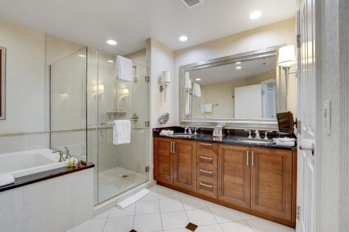 a bathroom with a shower and a sink and a tub at MGM Studio Suite with POOL VIEW Tower 1 in Las Vegas