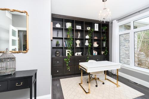 a room with a desk and a shelf with plants at Luxury Forest Oasis 4 beds 4 baths and Hot tub in Cocagne 