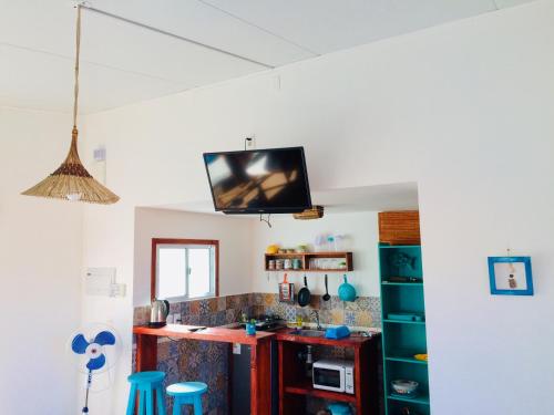 a kitchen with a tv hanging from the ceiling at Posada Agua Marina in La Paloma