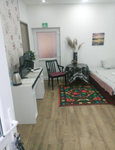 a bedroom with a bed and a desk and a table at Reteganu Apartment in Dej