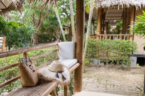 a hat sitting on a bench with a hat at Orion Healing Centre in Srithanu