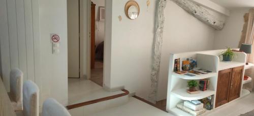 a room with a staircase and a mirror on the wall at "Les Chacobins" - appart'étape avec Garage Vélos in La Réole