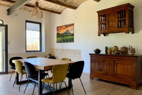 une salle à manger avec une table et des chaises en bois dans l'établissement GROOMI The winegrower- Swimming pool bowling alley and air conditioning !, à Beaulieu