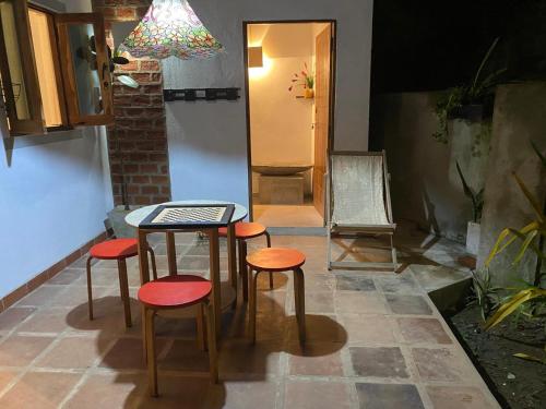 a table and four stools in front of a door at Suji's Villa in Colombo
