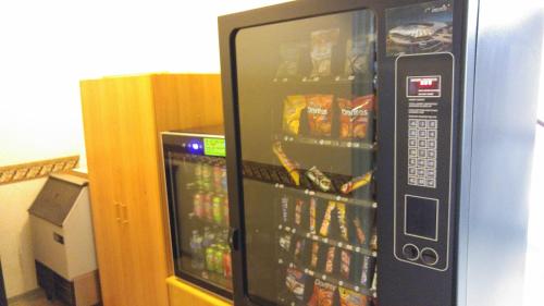 a vending machine filled with lots of food and drinks at Crossfield Country Inn in Crossfield