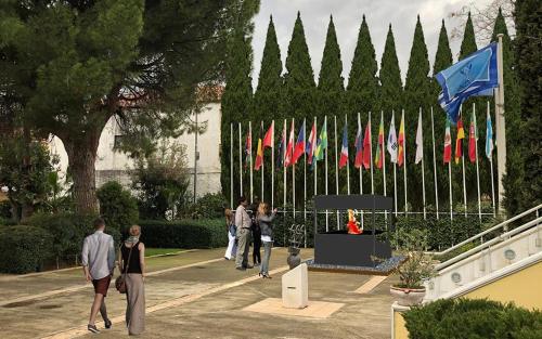 a group of people walking around a bunch of flags at Marathon VS LUXURY VILLA in Grammatiko
