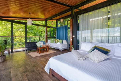 a bedroom with a bed in a room with windows at The Riverston Grand in Matale