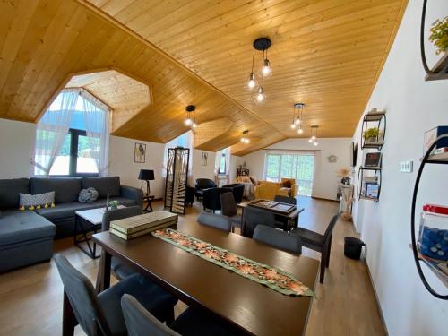 a living room with a table and a couch at Aurelia Hotel & Restaurant in Dilijan