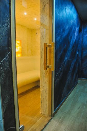a glass door to a room with a bed at Zlatibor Argonath Relax&Spa in Zlatibor