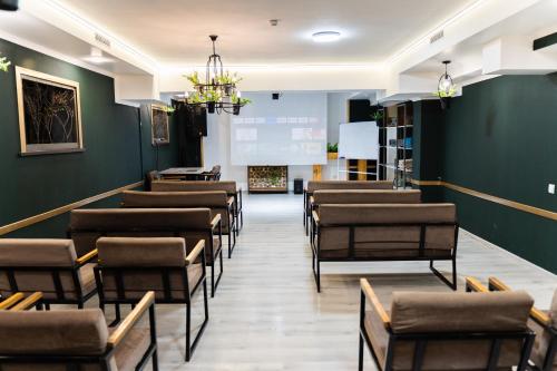 a row of chairs in a room with green walls at Cube House Osh in Osh