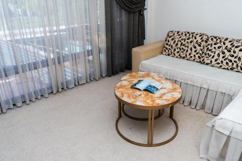 a living room with a couch and a table at Cube House Osh in Osh