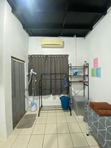 a bathroom with a shower with a shower curtain at Julian Homestay in Tuaran