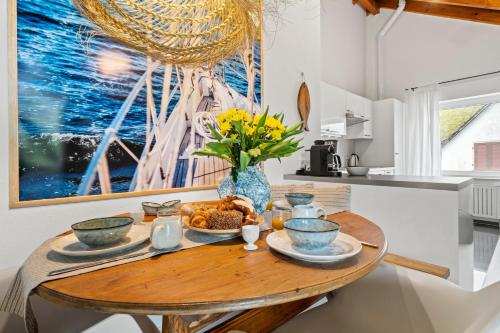 a kitchen with a wooden table with food on it at Bootshaus-Suite in Überlingen