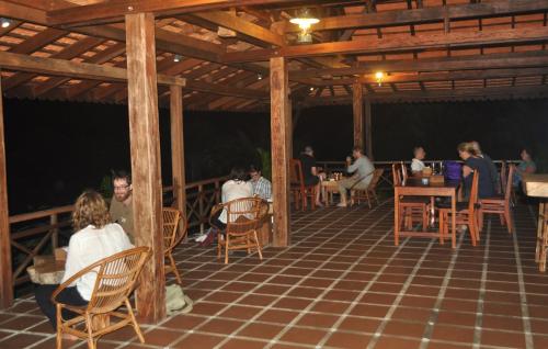 a group of people sitting at tables in a pavilion at Khmer Hands in Kep