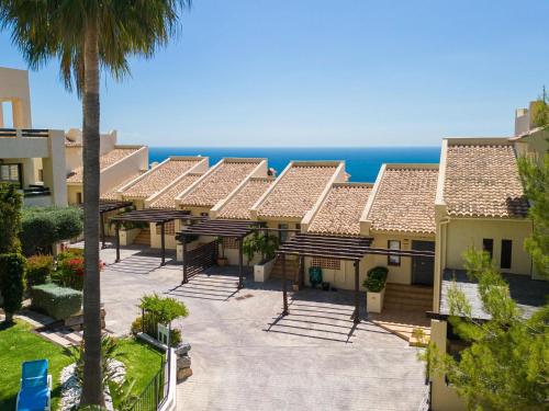 a row of houses with the ocean in the background at Belvilla by OYO Casa Panorama Altea Hills in Altea la Vieja