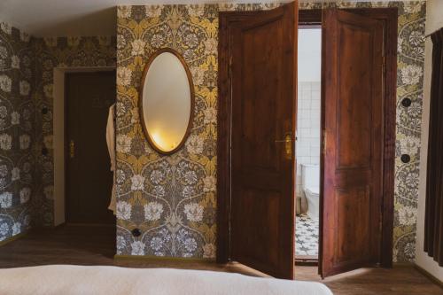 a bedroom with a mirror on a wall at Amante Boutique in Kuressaare