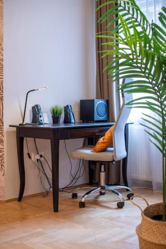 an office with a desk with a computer and a chair at Be a Budapester in Budapest