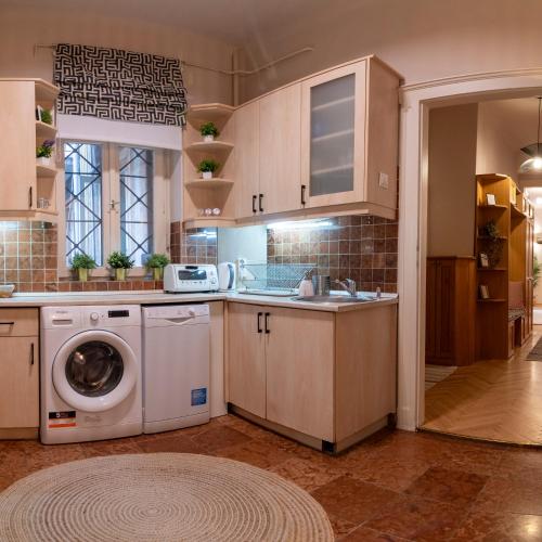 a kitchen with a washing machine and a sink at Be a Budapester in Budapest