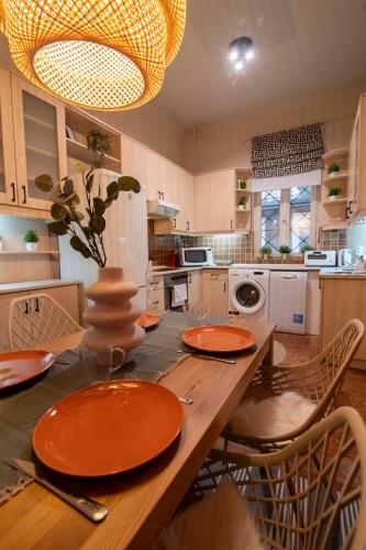 a kitchen with a table with orange plates on it at Be a Budapester in Budapest