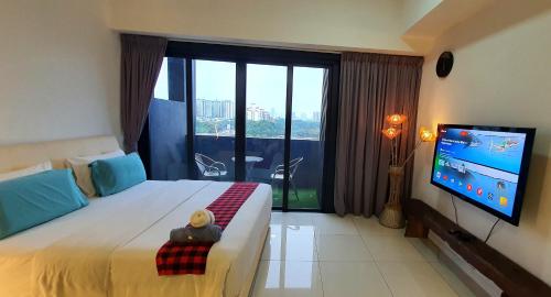 a hotel room with a bed with a tv at MCity Jalan Ampang KLCC in Kuala Lumpur