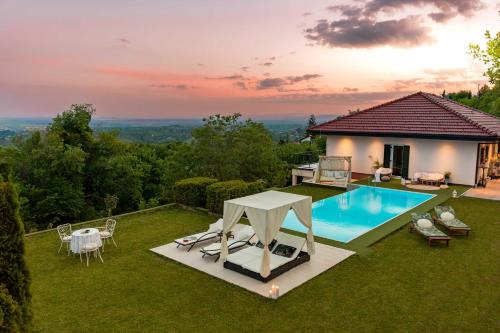 a backyard with a swimming pool and a house at Villa Plešivica view - Infinity Pool & Private Spa in Plešivica
