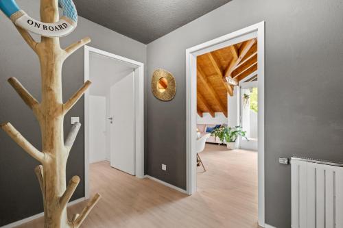 a hallway with a tree in the middle of a house at Bootshaus-Suite in Überlingen