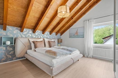 a bedroom with a bed and a large window at Bootshaus-Suite in Überlingen