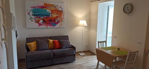 a living room with a couch and a table at A casa di Emi e Giò in Rome