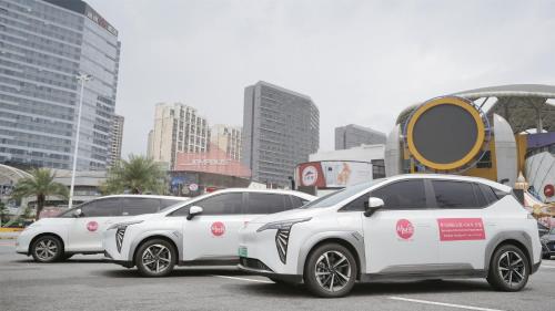 a row of white cars parked in a parking lot at Serveyou International Apartment Hotel - Free Airport Pickup & Free Canton Fair shuttle & Paid City Tour in Zengcheng