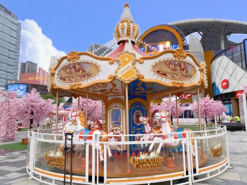 a merry go round at the amusement park at Serveyou International Apartment Hotel - Free Airport Pickup & Free Canton Fair shuttle & Paid City Tour in Zengcheng