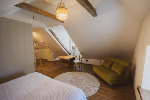 a bedroom with a bed and a couch and a table at Amante in Kuressaare