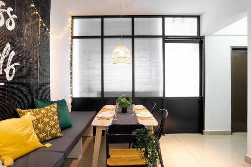 a dining room with a bench and a table at Chic - 4 bedroom - Projector - Ipoh Town - Sleep8 in Ipoh