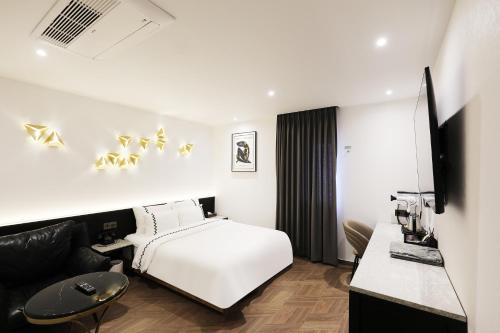 pokój hotelowy z łóżkiem i kanapą w obiekcie Gaeul Hotel w mieście Chungju