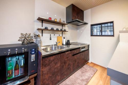 a kitchen with a sink and a television at NARANOYA in Nara