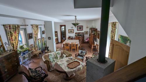 a living room with a table and a dining room at Chambre d'Hôtes La Grenade Bleue in Pons