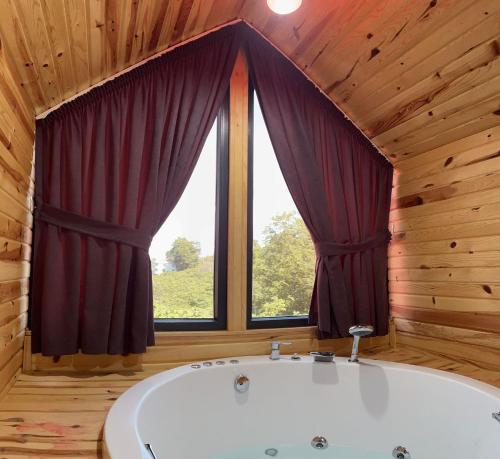 a bath tub in a room with a window at Five Stars Apart in Trabzon