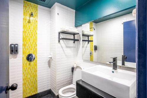 een badkamer met een wastafel en een toilet bij Hotel Olympic Malaysia Kuala Lumpur in Kuala Lumpur