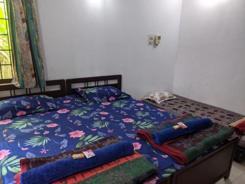 a bed with two pillows on it in a bedroom at Siderbhan Homestay in Chikmagalūr