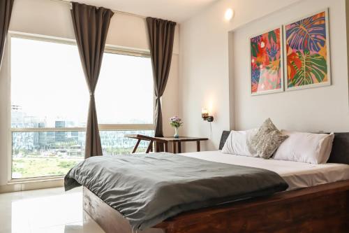 a bedroom with a bed and a large window at Stylish 3BHK Penthouse W/Terrace Steps from EON IT in Pune