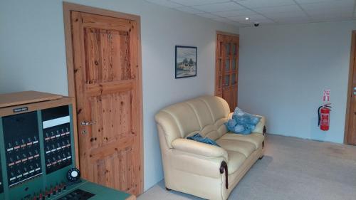 a living room with a couch and a laptop at K15HOSTEL guest apartments in Kobela