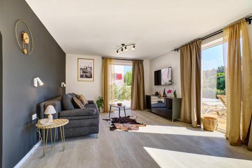 a living room with a couch and a table at VILLA RITA ARTaTORE in Mali Lošinj