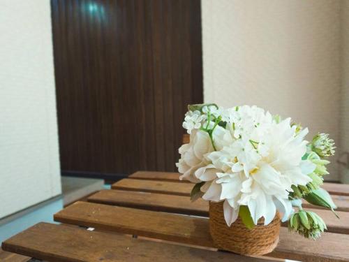 a bouquet of white flowers in a basket on a table at 楓 in Osaka