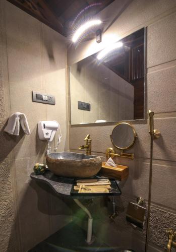 a bathroom with a sink and a mirror at Toyam by Orchid Hotels in Bhor