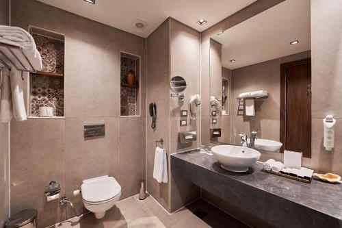 a bathroom with a sink and a toilet at True Beach Resort in Marsa Alam City