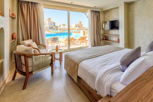 a bedroom with a bed and a view of a pool at True Beach Resort in Marsa Alam City