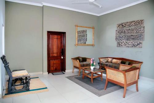 a living room with a couch and chairs and a table at Homely stay in the heart of Osu - Studio 2 in Accra